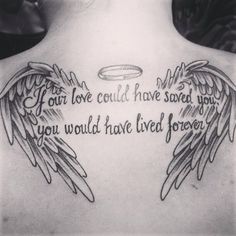 the back of a woman's neck with angel wings and an inscription on it