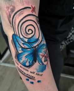 a blue butterfly tattoo on the arm