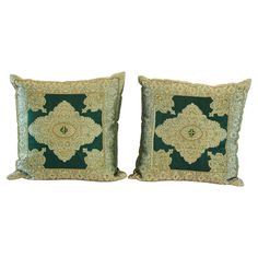 two green and gold pillows on white background