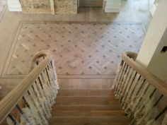 an aerial view of a wooden staircase in a house