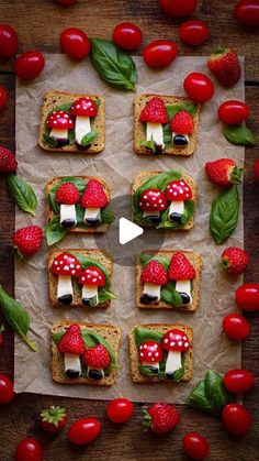 food is arranged on top of paper and placed in the shape of mushrooms with strawberries