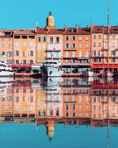 several boats are docked in the water near buildings