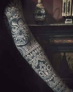 a man's arm with an intricate tattoo design on the side of his arm