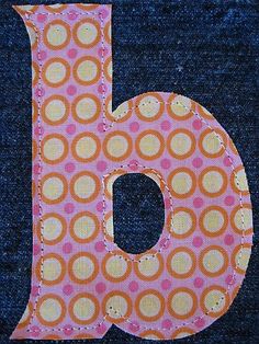 the letter b is made out of fabric and has polka dots on it, as well as