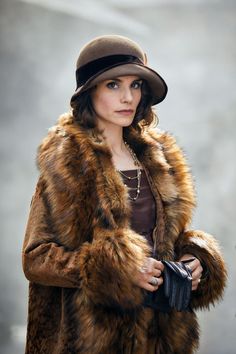 a woman wearing a fur coat and hat