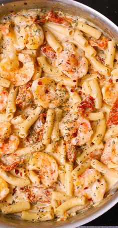 pasta with shrimp and tomato sauce in a skillet ready to be cooked on the stove