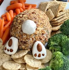 a white plate topped with crackers and veggies