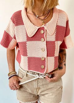 a woman with blonde hair wearing shorts and a red and white checkered shirt is posing for the camera