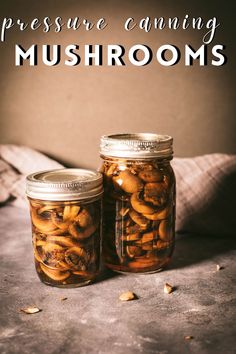 two jars filled with mushrooms sitting on top of a table next to each other and the words pressure canning mushrooms above them