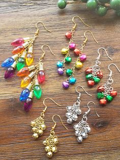 six pairs of colorful earrings sitting on top of a wooden table