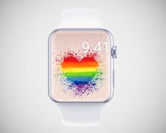 an apple watch with a heart painted on the screen and rainbow paint splatters all over it