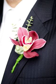 a man in a suit with a boutonniere and flower on his lapel