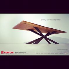 a wooden table sitting on top of a white floor next to an advertisement for carlton furniture