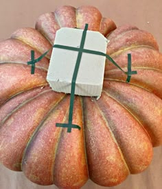 a cake shaped like a pumpkin with a box on top