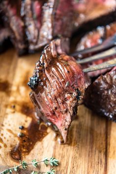 the steak is being cooked on the cutting board