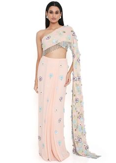 Blush pink georgette embroidered choli with attached pallu with hanging colorful tassels and embroidered pre-stitched skirt. Disclaimer: Since we are a made-to-measure brand and our dyeing process and embroidery are handcrafted, there may be slight variations in the color and embroidery of the actual product. The print placement may also vary from what is represented in the images shown on the product page. Pink Embroidered Pre-draped Saree For Reception, Festive Pink Pre-draped Saree With Floral Embroidery, Traditional Pink Pre-draped Saree With Floral Embroidery, Traditional Pink Floral Embroidered Pre-draped Saree, Pink Embellished Pre-draped Saree For Festivals, Embellished Pink Pre-draped Saree For Festivals, Traditional Party Saree With Tassels, Pink Embroidered Floor-length Pre-draped Saree, Embroidered Floor-length Pink Pre-draped Saree