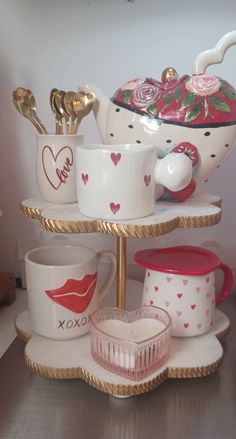 three tiered tray with cups and saucers on it