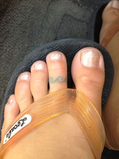 a person's feet with gold glitter on them