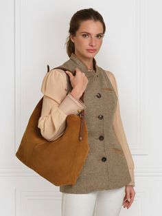 Our stylish and spacious shoulder bag, the Tetbury is part of a much-loved family. With a slouchy silhouette, and a range of carefully-considered style touches, it feels relaxed yet refined. Wear slung over your shoulder for days out or the office. Handcrafted in Spain, from soft sustainably sourced materials, we’ve added touches like the braided over-shoulder handle, and understated branding detail, such as shiny light gold shield hardware and an embossed logo. The microfibre-lined large compar Timeless Shoulder Bag For Travel In Fall, Timeless Leather Handled Crossbody Shoulder Bag, Chic Beige Hobo Bag With Leather Trim, Classic Hobo Bag With Leather Handles For Work, Leather Handles Hobo Shoulder Bag For Work, Timeless Hobo Bag With Removable Pouch, Timeless Everyday Satchel Shoulder Bag, Chic Hobo Bag With Leather Trim For Daily Use, Timeless Brown Shoulder Bag With Removable Pouch