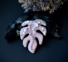 Look at this brooch- this is gorgeous accessory for your outfit. And good gift idea. Made with crystals and pearls, Japanese seed beads, back side stitched with natural leather. Sizes: length 2.2 inches, width 2inches. more brooches here https://www.etsy.com/shop/suzidesign?ref=simple-shop-header-name&listing_id=717056112&section_id=16478861 Elegant Handmade Pink Brooches, Pink Monstera, Luxury Embroidery, Embroidery Brooch, Beaded Charms, Beads Embroidery, Side Stitch, Beaded Leaf, Leaf Brooch