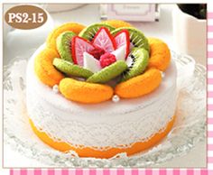 there is a cake decorated with fruit and flowers