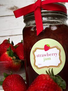 strawberry jam in a jar with strawberries around it