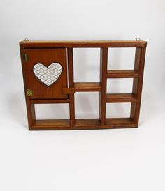 a wooden shelf with a heart cut out of the front and side panels on it