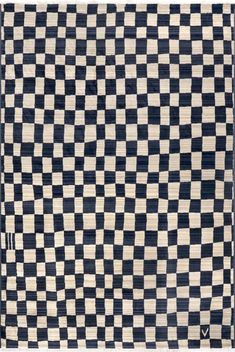 a black and white checkerboard rug with an arrow on the bottom right corner