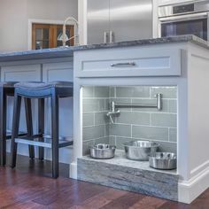 a kitchen with an oven, counter and stools