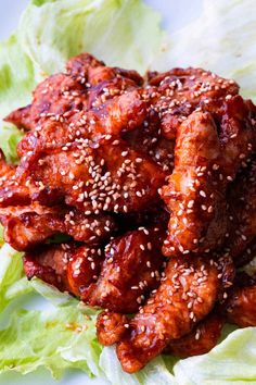 chicken wings with sesame seeds and lettuce on a plate