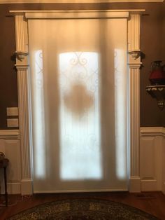 a door with frosted glass on it in front of a wall and floor rug