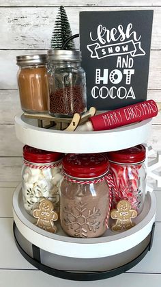 three tiered spice rack with jars and christmas treats on it, along with a chalkboard sign