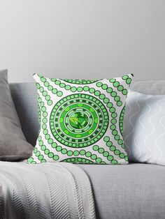 a green and white throw pillow sitting on top of a couch