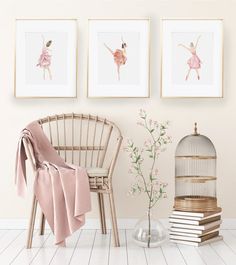 three framed ballet pictures hang on the wall next to a chair and birdcage