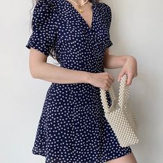 For summer daytime strolls. This wrap dress features short sleeves and a romantic floral print on a navy background. We love this dress paired with pearls. Details: Polyester Cold Hand Wash / Cool Iron Please refer to fabric swatch for a more accurate color Size / Fit: Length is measured from centre back Model wears a Small Model Info: Chest 82 cm Waist 65 cm Hips 88 cm Height 165 cm SIZE CHART Bust Waist Length Small 88 cm 70 cm 80 cm Medium 92 cm 74 cm 81.5 cm Large 96 cm 78 cm 83 cm Navy Wrap Dress, Winter Activewear, Romantic Floral Print, Lapel Pins Mens, Bodycon Dresses Casual, Umbrellas Parasols, Fabric Swatch, Navy Background, Clothing Photography