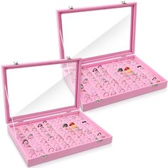 two pink jewelry boxes filled with lots of earrings