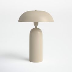 a white table lamp sitting on top of a white floor