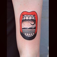 a person with a tattoo on their arm that has an image of a hamburger in the mouth