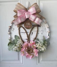 a door hanger decorated with pink flowers and a large bow that says happy mother