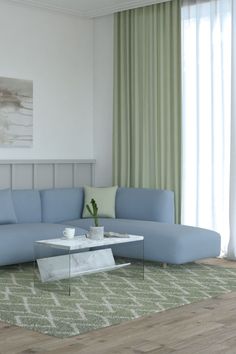 a living room with a blue sectional couch and coffee table in front of the window