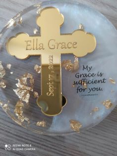 a glass plate with a cross on it and some gold flakes around the edge