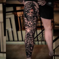 the legs and arm of a man with tattoos on them, both covered in black ink