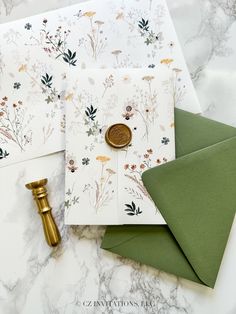 two envelopes, one with a wax stamp and the other with flowers on them