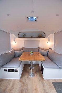 the inside of a boat with couches and tables