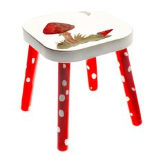 a red and white stool with mushrooms painted on it