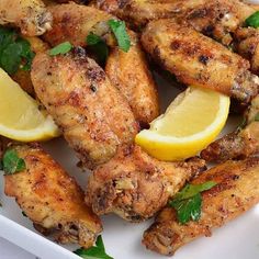 lemon pepper wings on a white plate with garnish