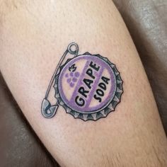 a close up of a person's leg with a tattoo on it that says grape pop