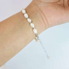 This romantic FRESHWATER PEARL Bracelet is made of a very fine quality of  Fresh Water pearls and 925 sterling silver for your special days! Freshwater pearls are real, cultured pearls, grown in lakes, rivers, as well as ponds. Most Freshwater pearls are white and resemble Akoya pearls, but they also produce a variety of pastel shades, including pink, lilac and peach. Measurements:- This Bracelet is 9 inches (adjustable) around your hand. ► ABOUT YOUR ORDER * All items are neatly packaged in our beautiful jewelry boxes and elegant organza bags. * All items are 100% gift-ready. * Each order comes with a personalized handwritten card and a branded Millennium Bride jewelry cloth. * Each order comes with a free gift. ► PERSONALIZTION * If your order is a gift, you may contact us with the recip Elegant Resizable Pearl Bracelet, Elegant Resizable Wedding Bracelets, Elegant White Resizable Jewelry, Wedding Pearl Bracelet With Adjustable Chain, Minimalist Adjustable Pearl Bracelet For Anniversary, White Gold Jubilee Pearl Bracelet For Wedding, Adjustable Jubilee Pearl Bracelet For Anniversary, Sterling Silver Bracelet With Clasp For Wedding, Adjustable Pearl Drop Bracelet As Gift