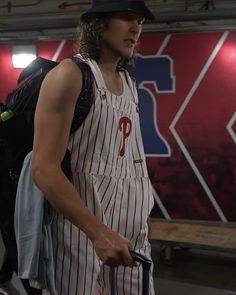 a man with a baseball cap and striped overalls