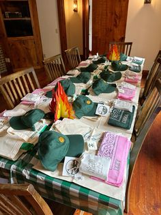 the table is covered with hats and t - shirts on it's long tables